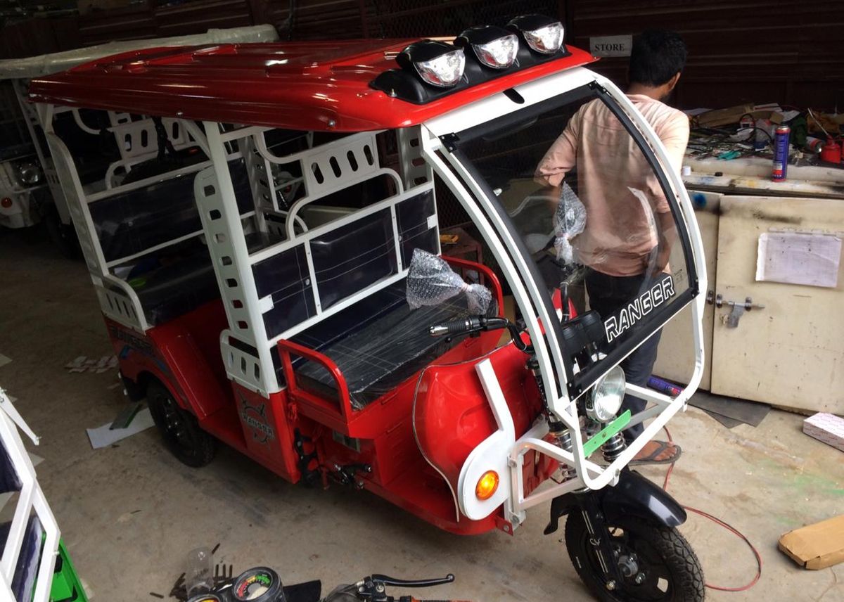 Electric three-wheeler on the assembly line being fitted out